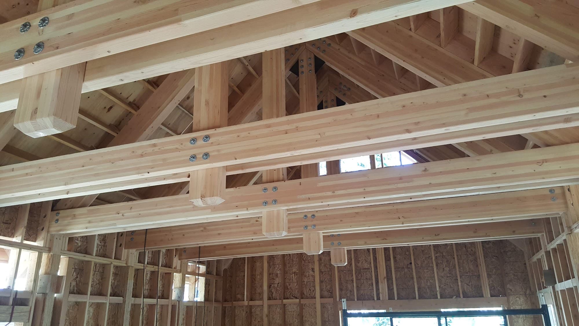 Heavy timber roof framing with metal connector plates — residential structural engineering by Palisade Engineering
