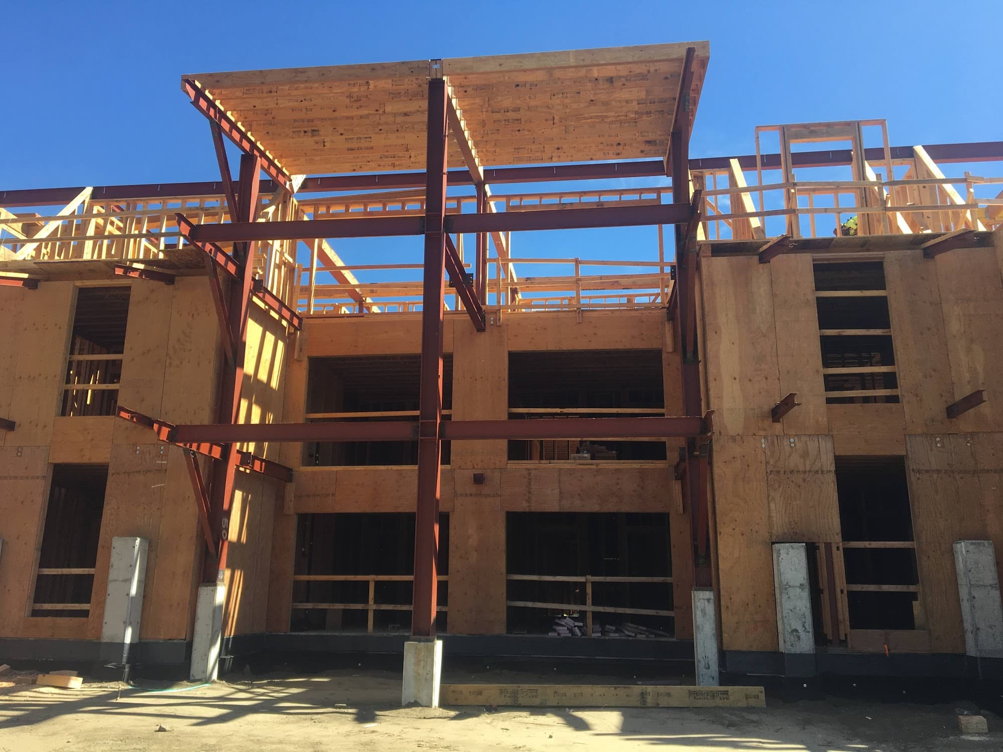 Multi-story wood-frame building with steel moment frames under construction — Palisade Engineering